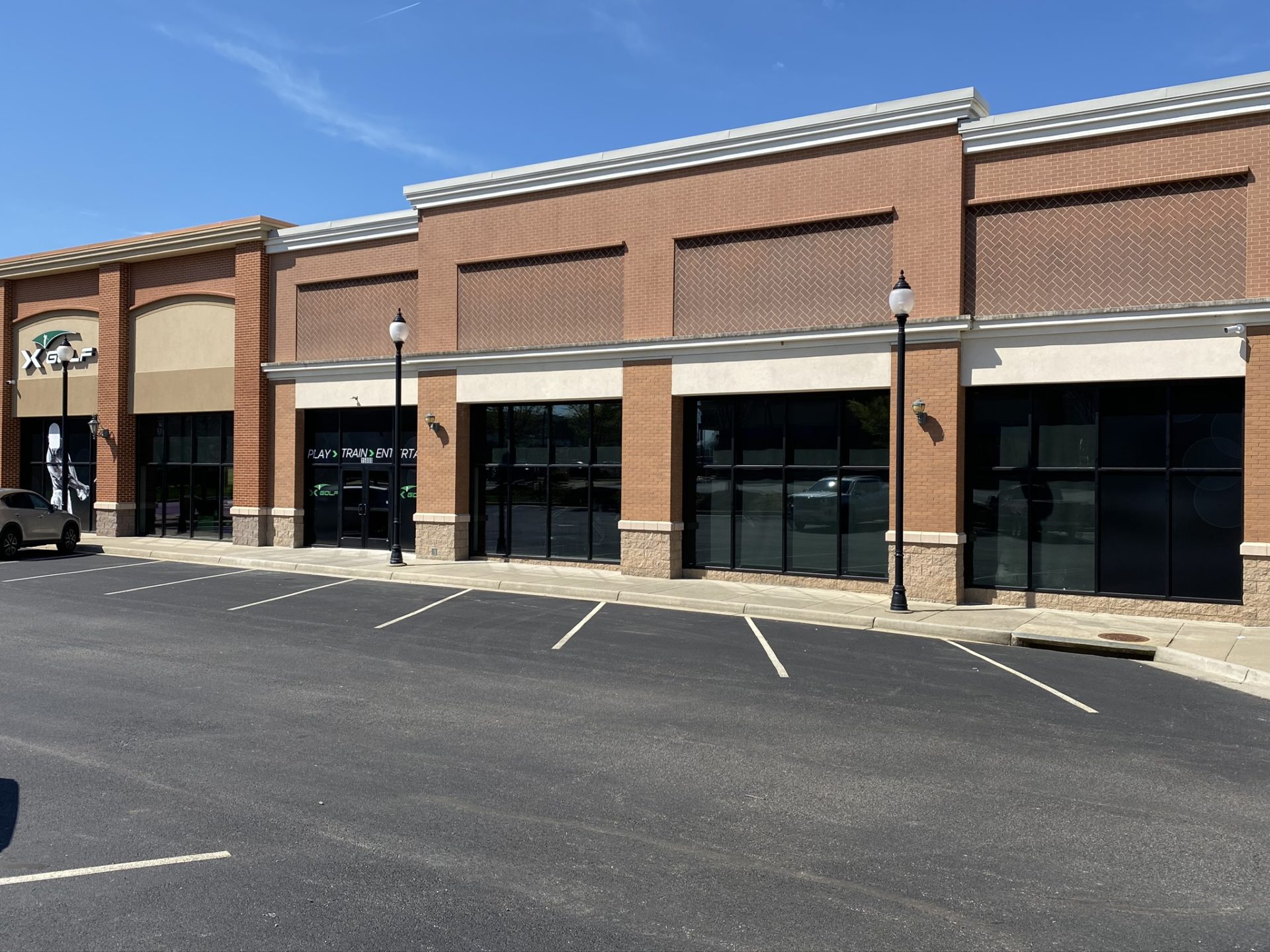 New storefront glass across a brick retail building